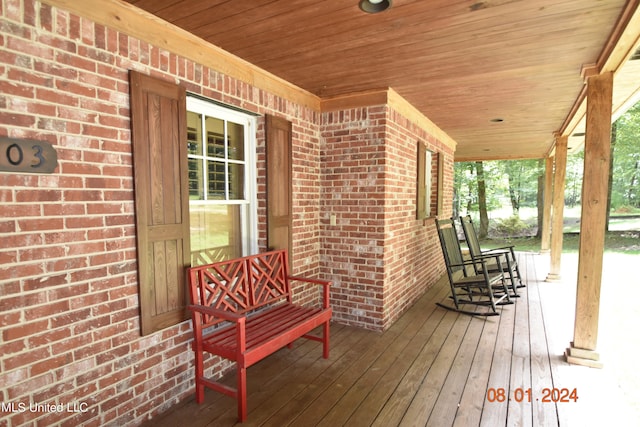 wooden terrace with a porch