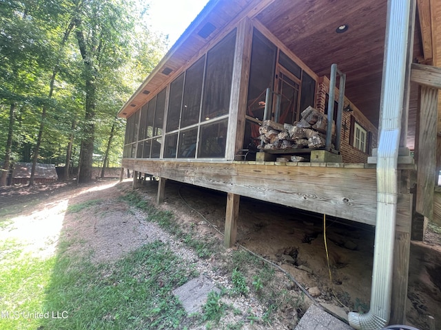 view of side of home with a sunroom