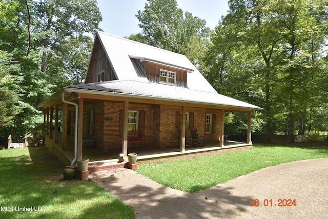 back of property featuring a porch and a yard