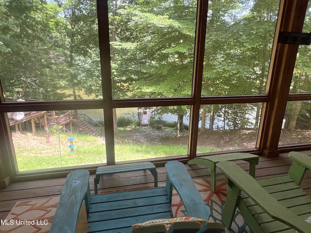 unfurnished sunroom with a water view