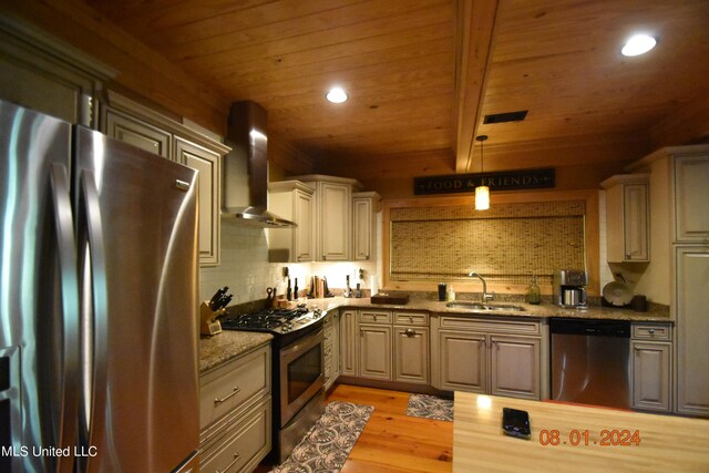 kitchen featuring wall chimney range hood, appliances with stainless steel finishes, sink, light stone countertops, and light hardwood / wood-style floors