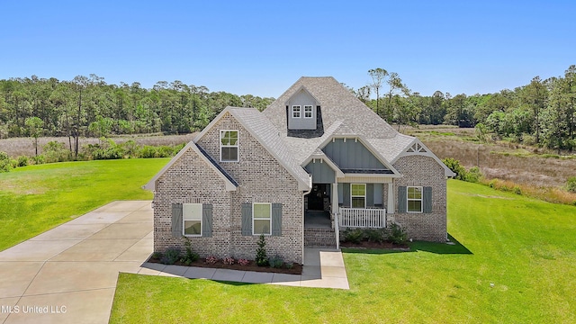 2918 Juliette Dr, Ocean Springs, MS 39564 - view of front of home with brick siding, a porch, and a front lawn
