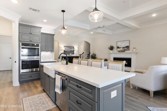 2918 Juliette Dr, Ocean Springs, MS 39564 - kitchen featuring gray cabinetry, stainless steel appliances, a sink, open floor plan, and beam ceiling