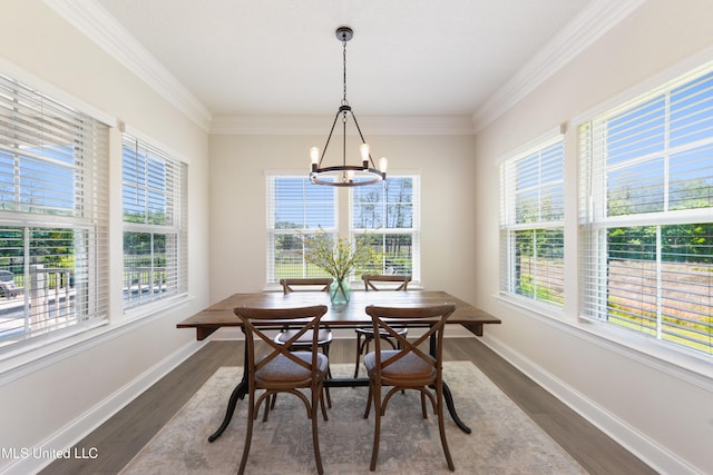 2918 Juliette Dr, Ocean Springs, MS 39564 - dining area with healthy amount of natural light, a chandelier, dark wood-style flooring, baseboards, and ornamental molding