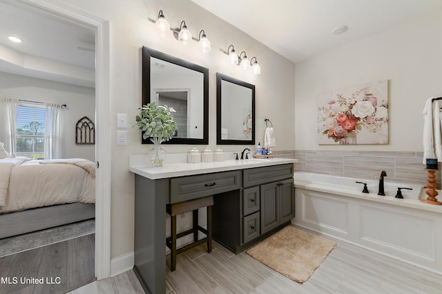 2918 Juliette Dr, Ocean Springs, MS 39564 - ensuite bathroom with a garden tub, vanity, and wood finished floors