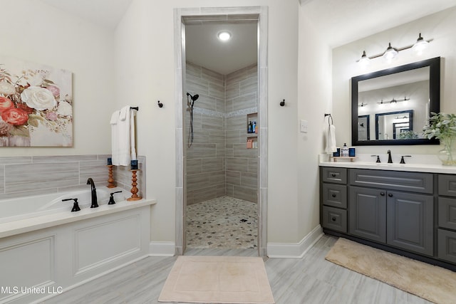 2918 Juliette Dr, Ocean Springs, MS 39564 - bathroom with a tile shower, vanity, a garden tub, and baseboards