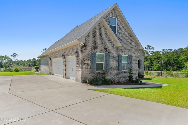 2918 Juliette Dr, Ocean Springs, MS 39564 - view of property exterior featuring driveway, brick siding, a garage, a lawn, and a shingled roof