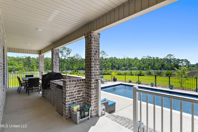 2918 Juliette Dr, Ocean Springs, MS 39564 - view of pool with fence, a patio, outdoor dining space, and view of wooded area