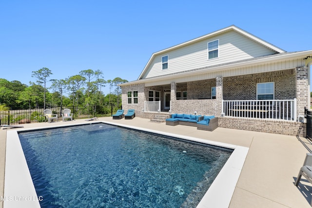 2918 Juliette Dr, Ocean Springs, MS 39564 - back of property with brick siding, an outdoor hangout area, a patio area, and fence