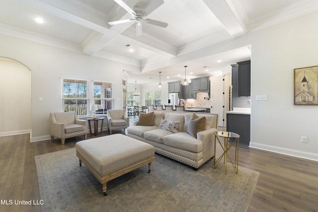 2918 Juliette Dr, Ocean Springs, MS 39564 - living room with ceiling fan, beamed ceiling, arched walkways, dark wood-style flooring, and ornamental molding