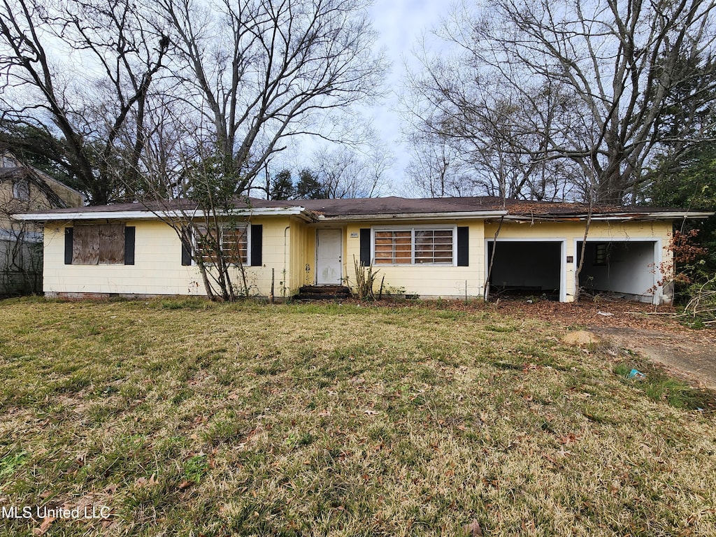 ranch-style home with a garage and a front yard