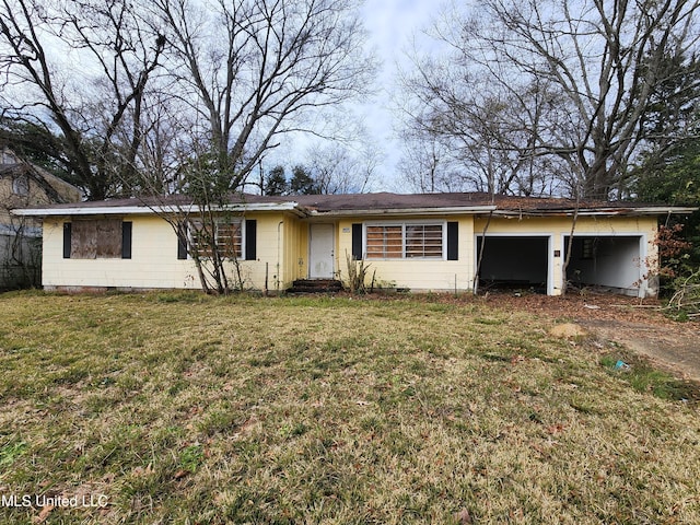 ranch-style home with a garage and a front yard