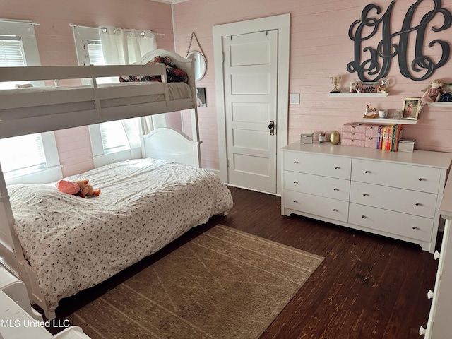 90 Holmes St, Lucedale, MS 39452 - bedroom with dark wood-type flooring and wooden walls