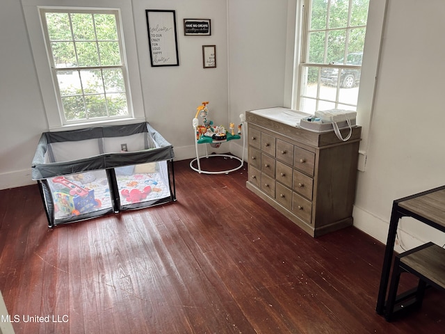 90 Holmes St, Lucedale, MS 39452 - bedroom featuring dark wood-type flooring and multiple windows