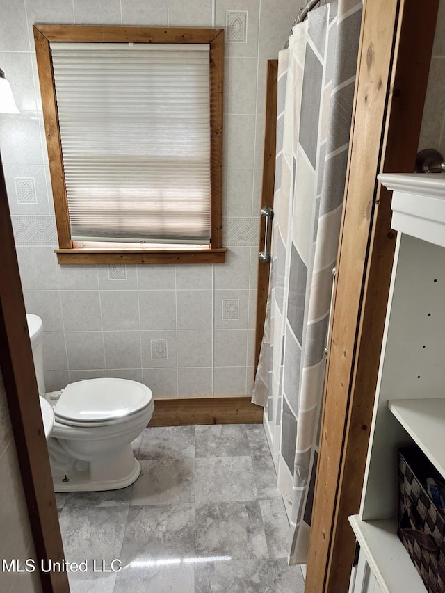 90 Holmes St, Lucedale, MS 39452 - full bathroom with tile walls, toilet, and a shower with shower curtain