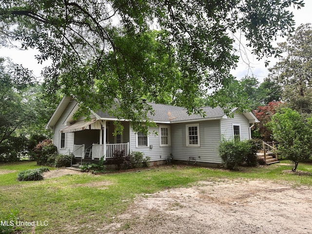 90 Holmes St, Lucedale, MS 39452 - view of front of house with a front yard, a shingled roof, and a porch