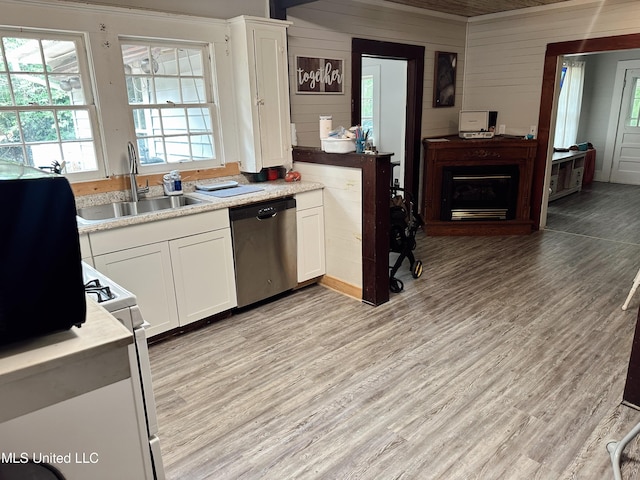 90 Holmes St, Lucedale, MS 39452 - kitchen with dishwasher, a sink, light countertops, light wood finished floors, and wooden walls