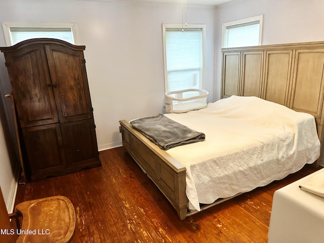90 Holmes St, Lucedale, MS 39452 - bedroom with dark wood-style flooring and baseboards