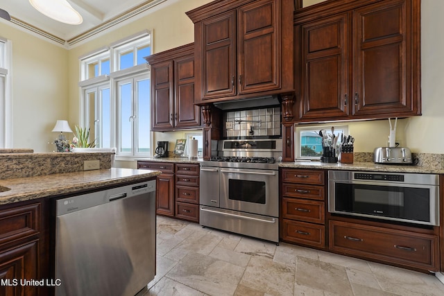 kitchen featuring stone tile floors, stainless steel appliances, ornamental molding, light stone countertops, and under cabinet range hood