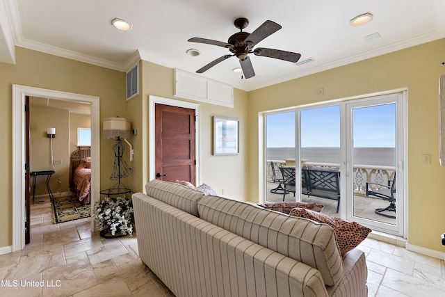 living room featuring stone tile flooring, visible vents, crown molding, and baseboards