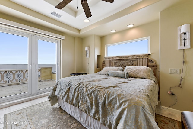 bedroom featuring visible vents, a raised ceiling, a ceiling fan, baseboards, and access to outside