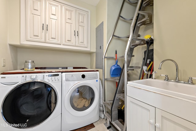 laundry room featuring electric panel, a sink, cabinet space, and washer and dryer