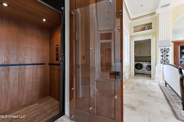 hallway featuring recessed lighting, elevator, stone finish flooring, and separate washer and dryer