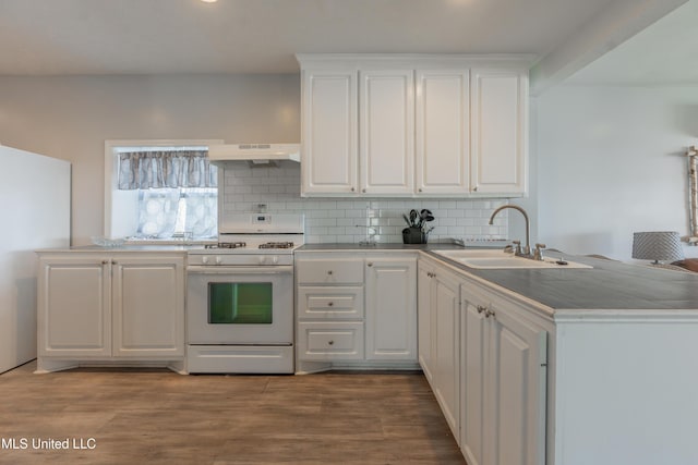 95 Nesting Site, Vicksburg, MS 39183 - kitchen featuring a peninsula, a sink, white cabinets, white gas range oven, and under cabinet range hood