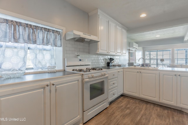 95 Nesting Site, Vicksburg, MS 39183 - kitchen with wood finished floors, white range with gas stovetop, a sink, white cabinets, and under cabinet range hood