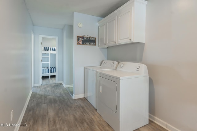 95 Nesting Site, Vicksburg, MS 39183 - clothes washing area featuring washing machine and clothes dryer, cabinet space, baseboards, and wood finished floors