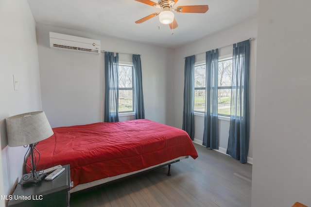 95 Nesting Site, Vicksburg, MS 39183 - bedroom with baseboards, a wall mounted AC, ceiling fan, and wood-type flooring