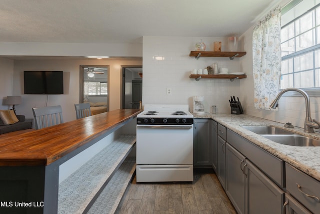 95 Nesting Site, Vicksburg, MS 39183 - kitchen featuring a sink, wood finished floors, backsplash, and white range with electric cooktop