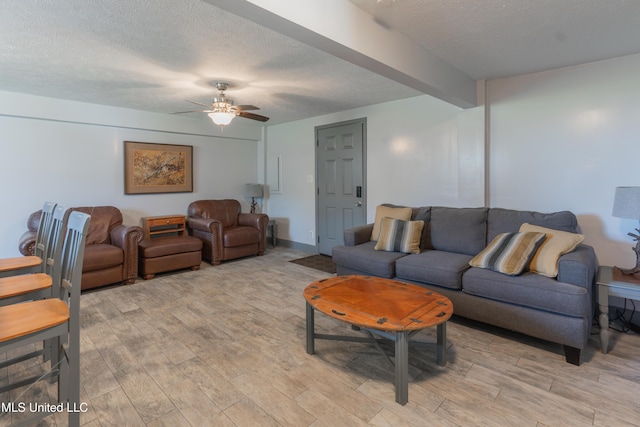 95 Nesting Site, Vicksburg, MS 39183 - living room with beam ceiling, light wood-style flooring, a ceiling fan, and a textured ceiling