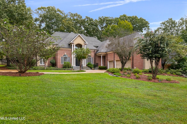 view of front of house featuring a front lawn and a garage