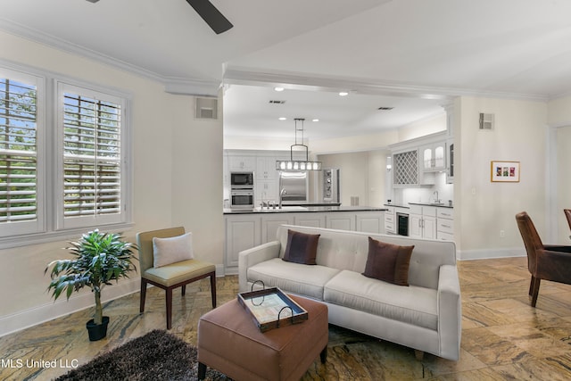 living room featuring crown molding, sink, and ceiling fan