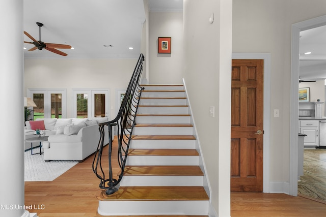 stairway featuring ornamental molding, hardwood / wood-style floors, and ceiling fan