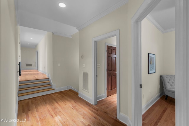 hall featuring wood-type flooring and ornamental molding