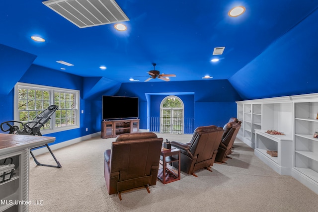 carpeted home theater room featuring ceiling fan, lofted ceiling, and plenty of natural light