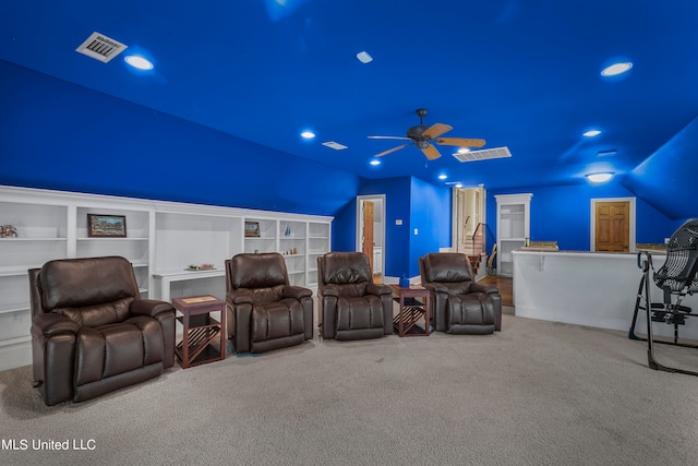 carpeted home theater room featuring ceiling fan, built in features, and vaulted ceiling