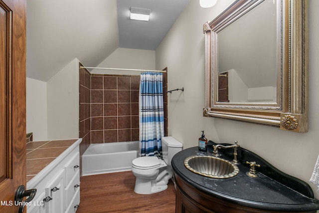 full bathroom featuring vanity, toilet, wood-type flooring, and shower / bathtub combination with curtain