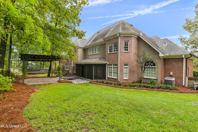 back of property with a pergola, a patio area, a lawn, and central air condition unit