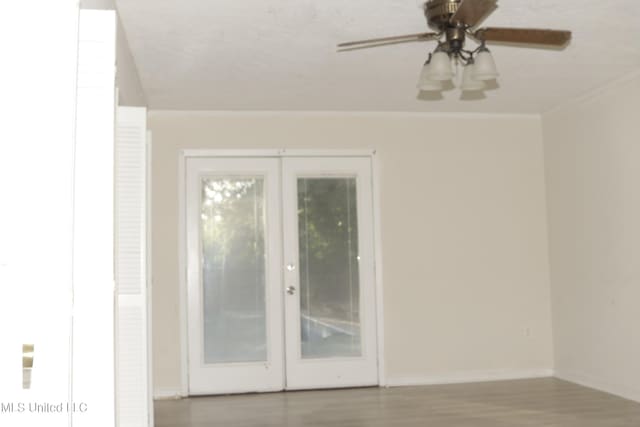 219 Lake Cove Dr, Jackson, MS 39212 - unfurnished room with ornamental molding, a ceiling fan, wood finished floors, and french doors