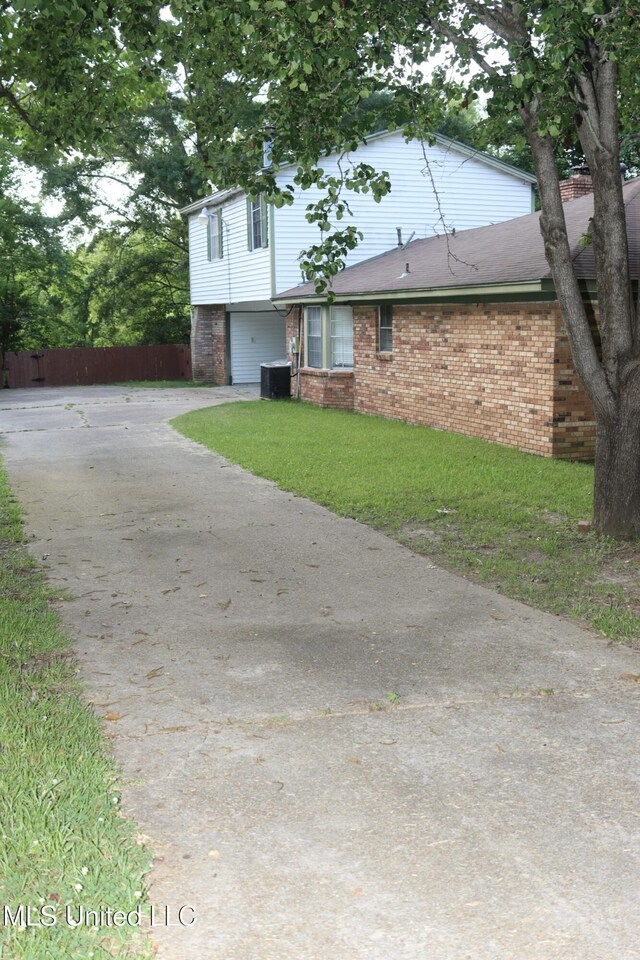 219 Lake Cove Dr, Jackson, MS 39212 - view of front facade with driveway, an attached garage, and brick siding