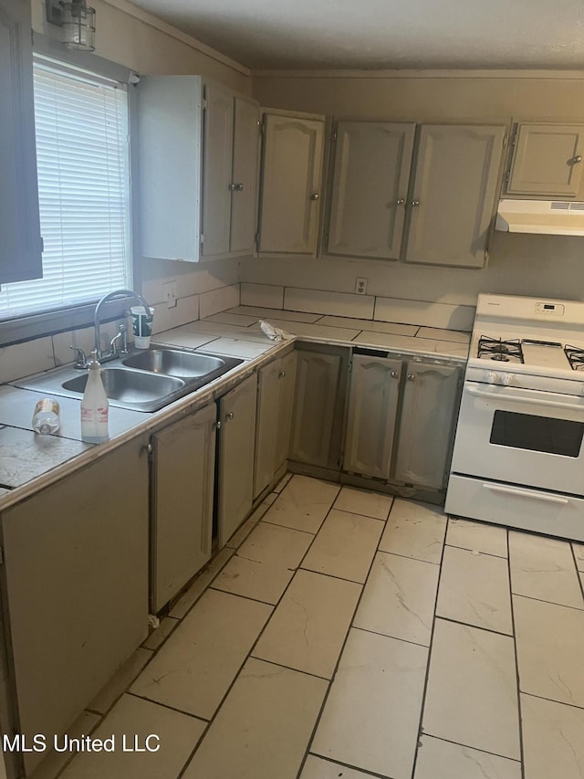 kitchen with gray cabinets, sink, and white gas range oven