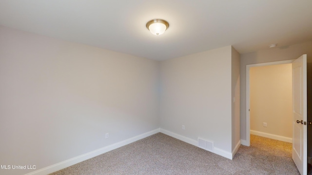 unfurnished room with light carpet