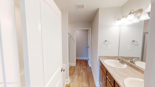 bathroom featuring vanity, hardwood / wood-style flooring, and an enclosed shower