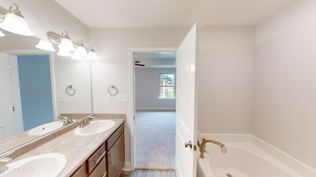 bathroom featuring a bathing tub, hardwood / wood-style flooring, and vanity