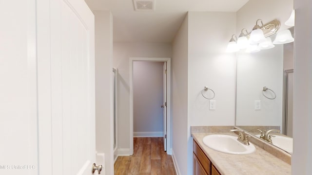 bathroom with vanity, hardwood / wood-style floors, and an enclosed shower