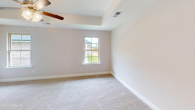 carpeted spare room with ceiling fan and a wealth of natural light