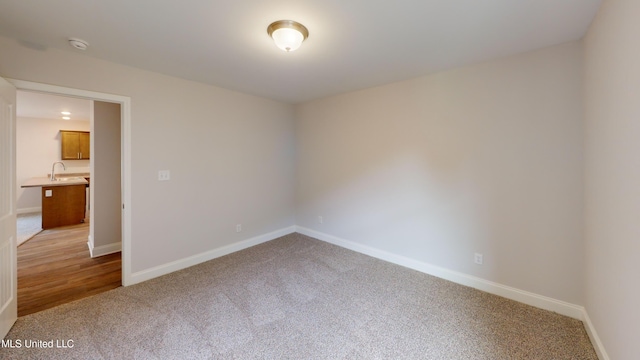 carpeted spare room with sink